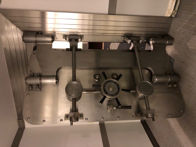Professional bank vault door installation showing advanced security mechanisms